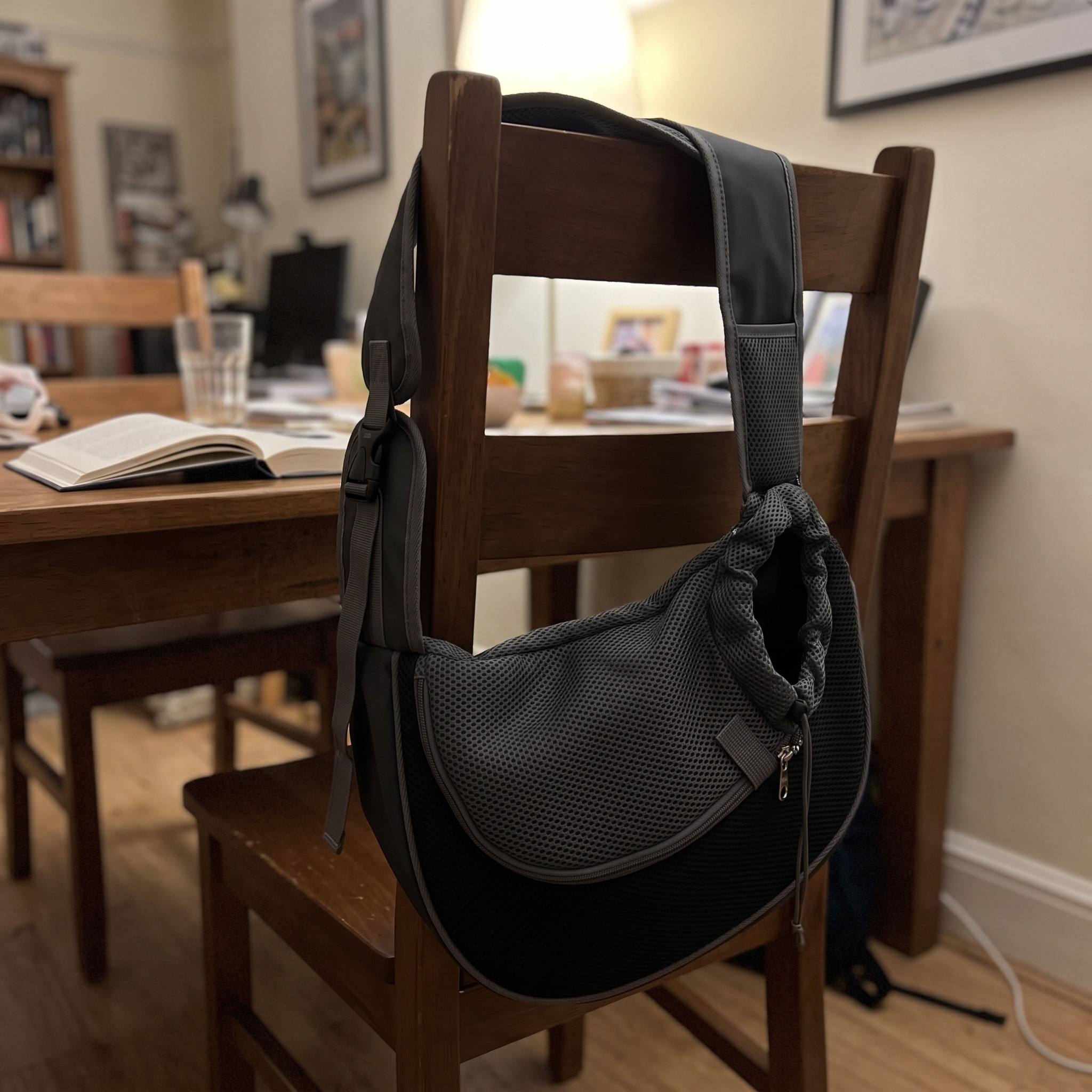 Black sling resting on a chair after an outing